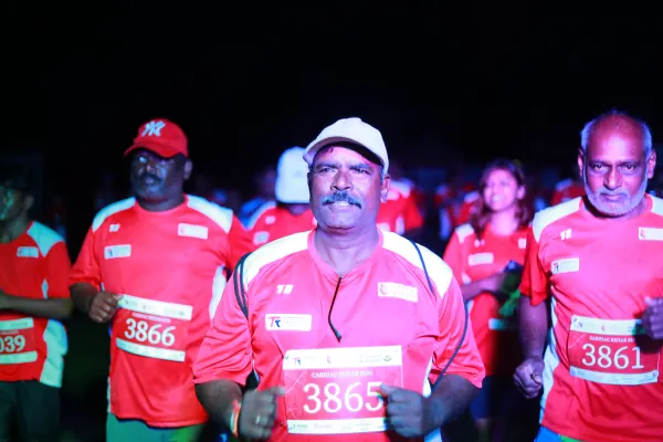 Veteran runners in the start crowd, faces lit and smiling