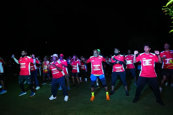 Wide view: whole field doing the warm-up in the dark