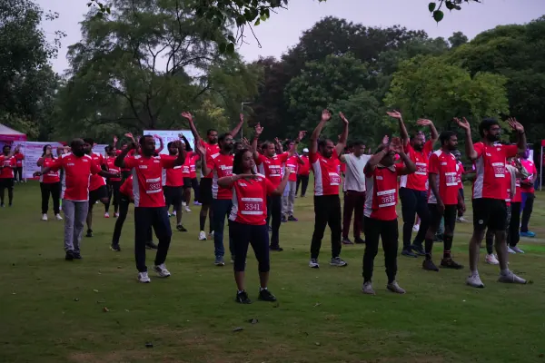 Rows of runners arms up