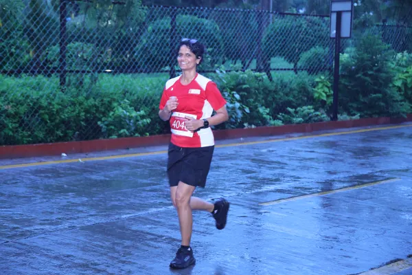 Runner in full stride on the wet road