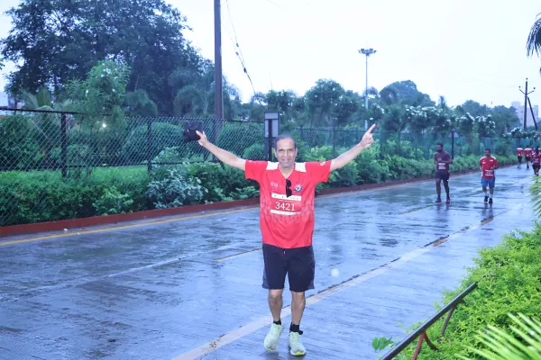 Arms-out runner in the rain