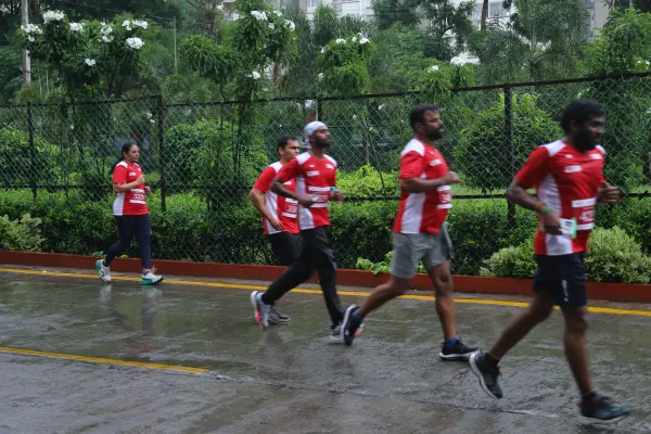 Group running past the hedges