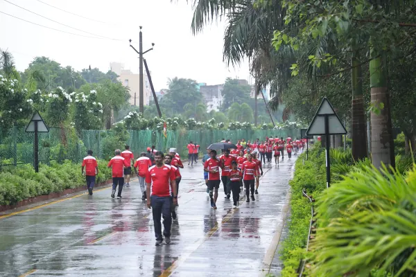 Wide view: a long stream of runners on the wet road