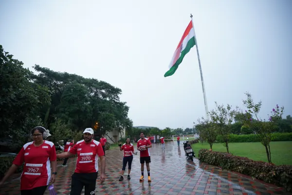 Runners walking under the flag