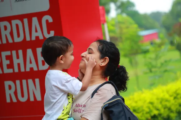 Child kissing his mother by the arch