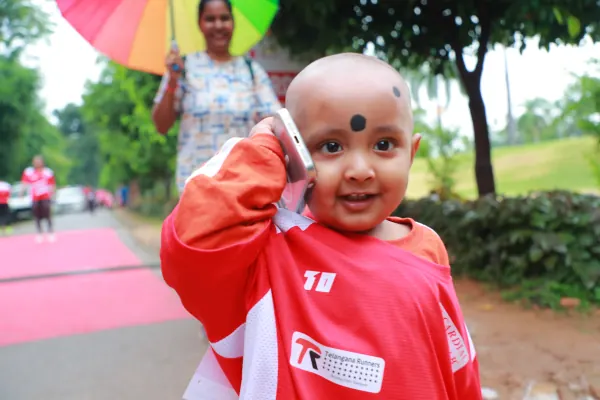 Smiling toddler in a race shirt