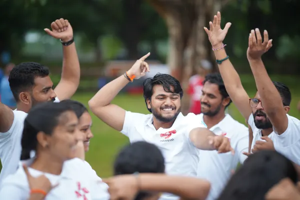 Volunteers dancing, arms raised