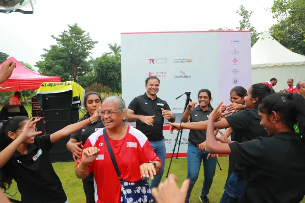 Grandmother dancing with volunteers